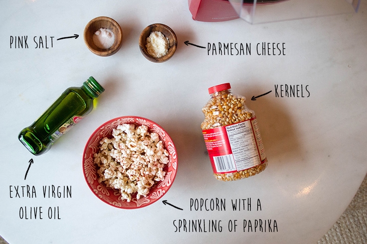 Pink salt, parmesan cheese, popcorn kernels, olive oil, and a pop of popped corn with paprika.