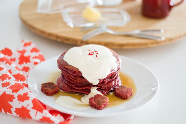Red velvet pancakes with a maple syrup buttercream topping.