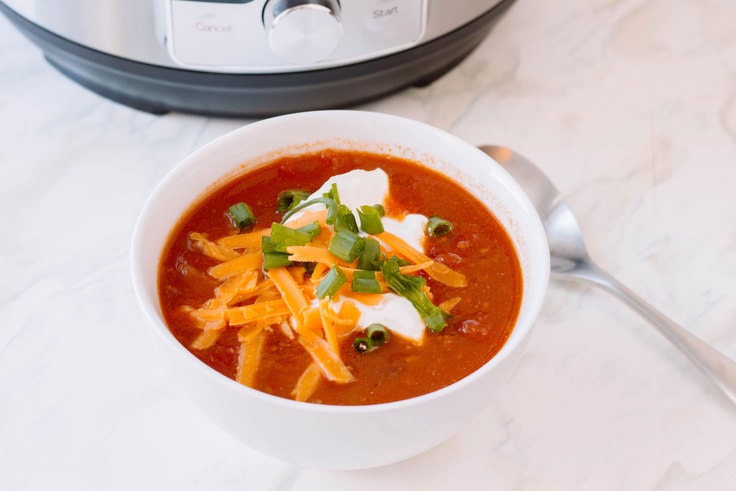 A warm bowl of chili in a crisp white bowl using the Instant Pot. Here is our very own recipe for Instant Pot Chili