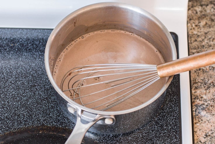 Whisking chocolate in a saucepan.