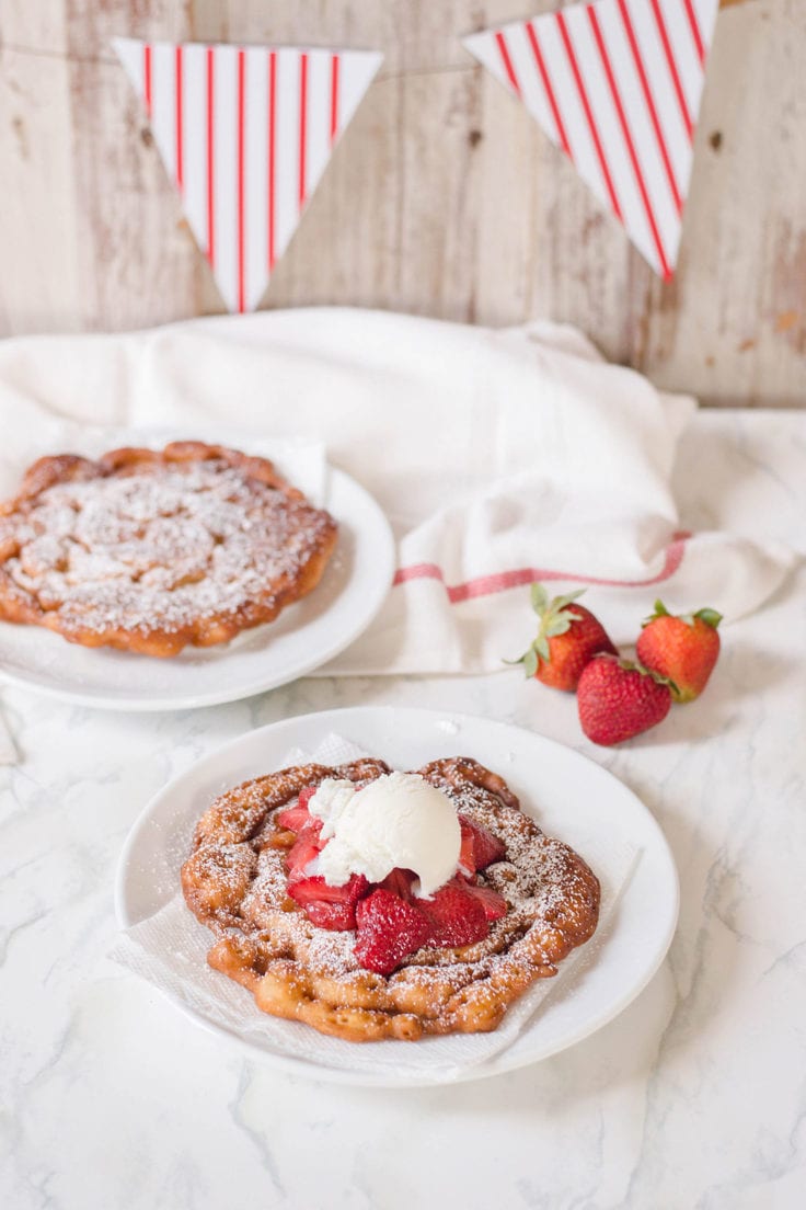 Topped with confectioners’ sugar, strawberries and ice cream, the flavor profile to this funnel cake is out of this world!