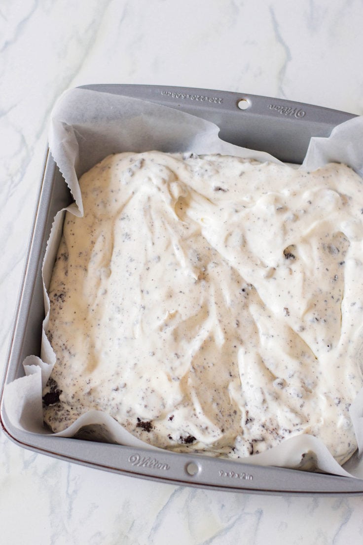 Oreo ice cream freezing in a metal cake pan.