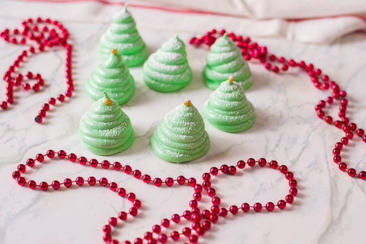 Green meringue cookies shaped like Christmas trees