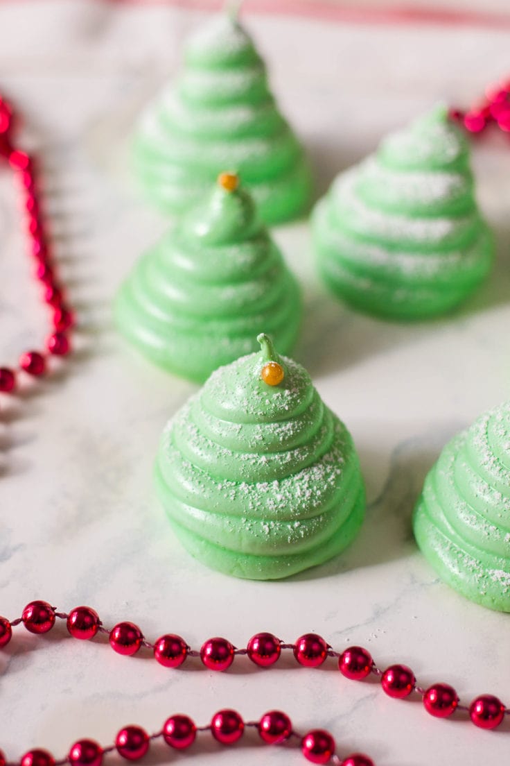 A close-up of Meringue Cookies that look like Christmas trees