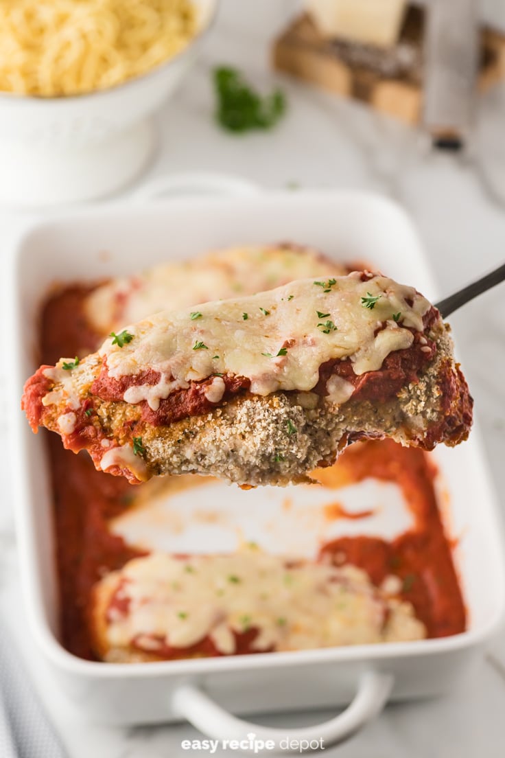 A piece of chicken parmesan topped with tomato sauce and mozzarella.
