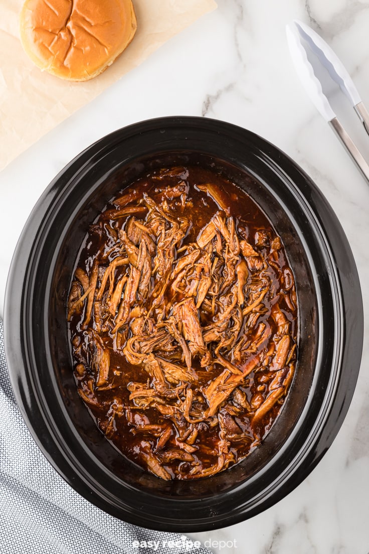 Pulled pork cooked in a slow cooker.