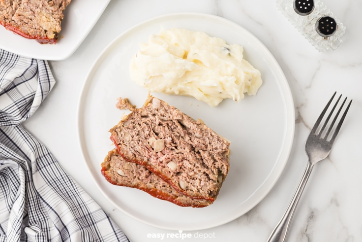 Slices of meatloaf served with mashed potatoes.