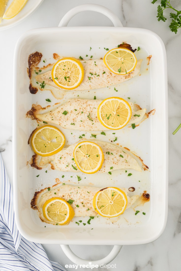 fresh baked tilapia in a casserole dish right out of the oven