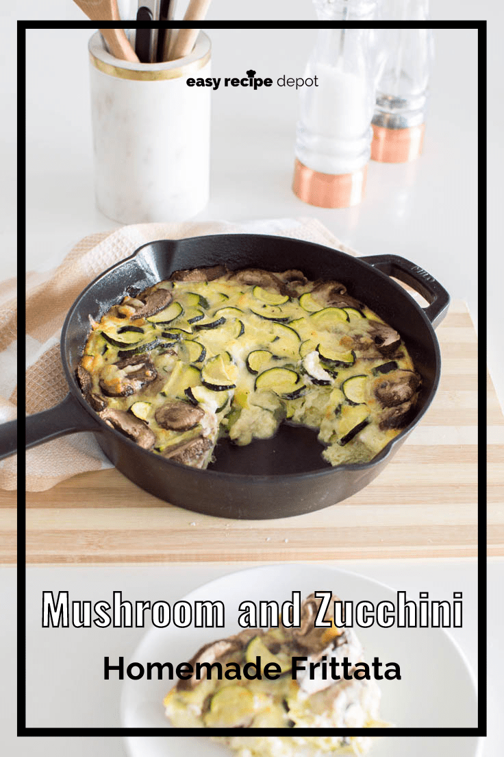 A cast iron skillet frittata, filled with mushrooms and zucchini, with a piece cut out of it