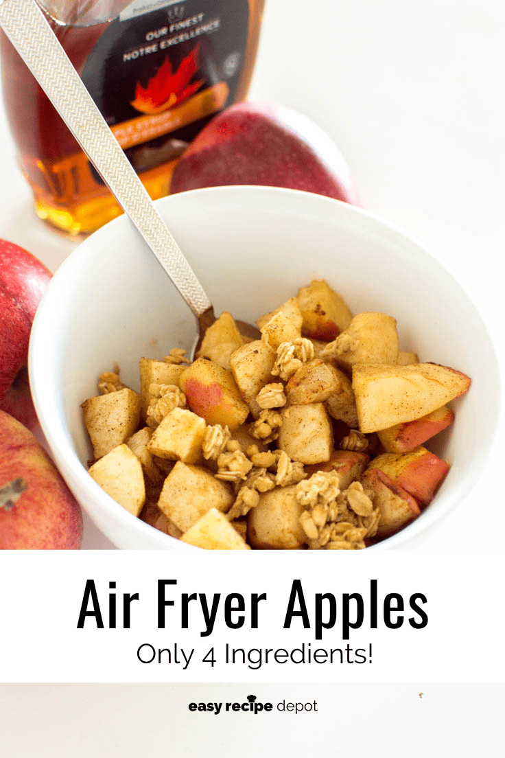 A spoon about to scoop up some chopped apples, freshly baked in the air fryer and topped with granola
