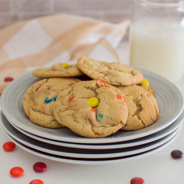 A closeup photo of a plate full of M&M cookies