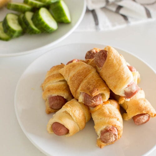 Aerial shot of pigs in a blanket on a white plate