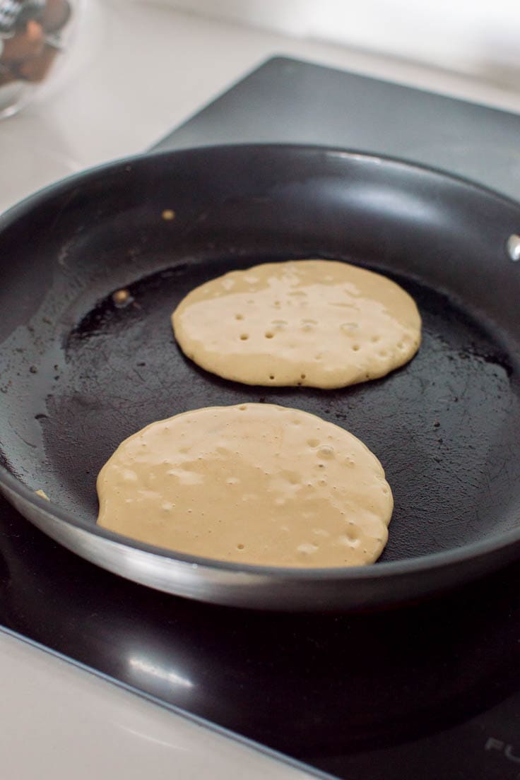 Brown Sugar Pancakes in the process of cooking in a non-stick frying pan