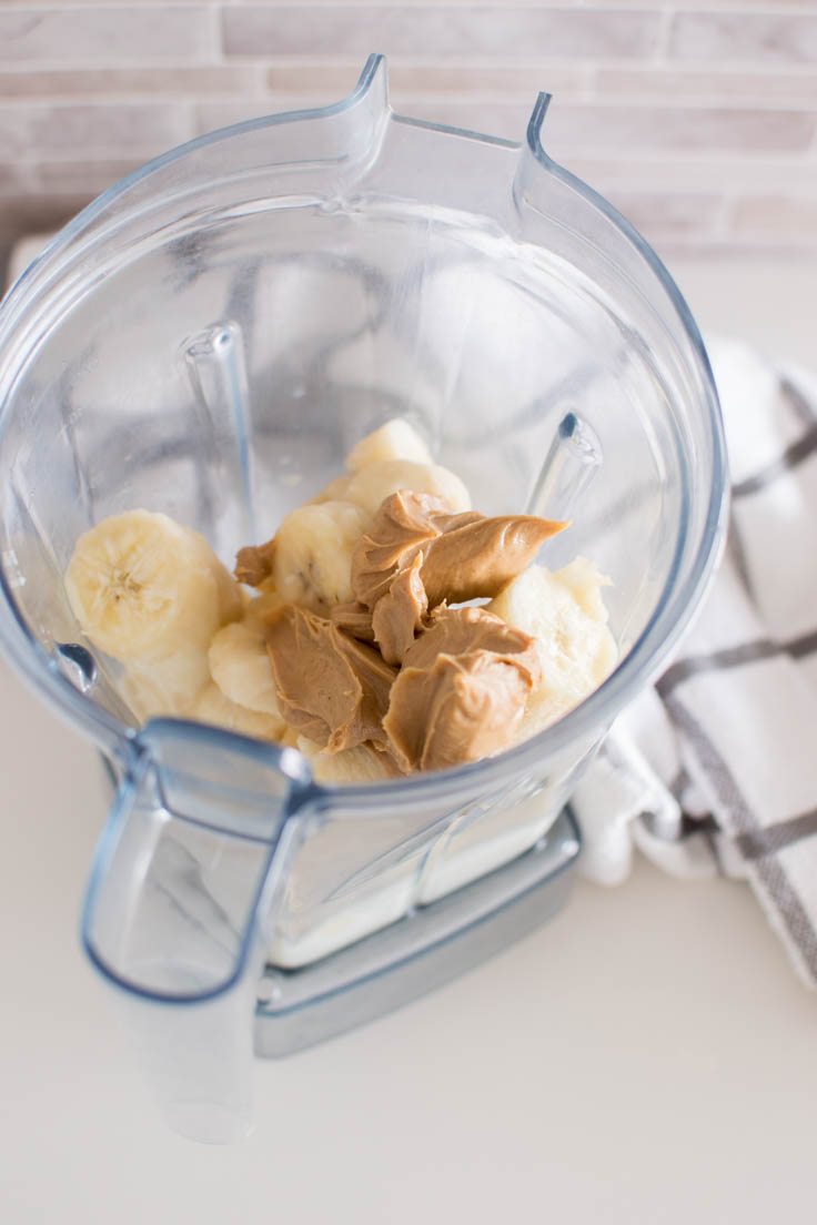 Bananas, almond milk and peanut butter to make a healthy version of a shamrock shake