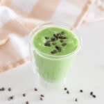 Aerial view of a green milkshake topped with mini chocolate chips
