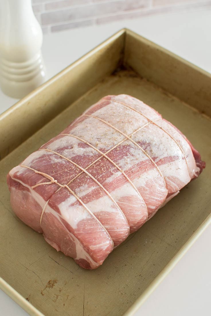 A raw pork loin on a non-stick pan