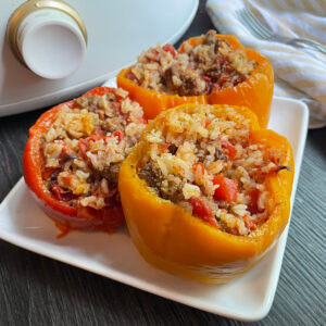 stuffed orange and red peppers on white plate