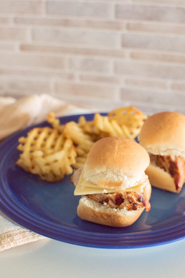 Easy Pork Tenderloin Sliders served on a blue plate with waffle fries