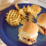 Aerial view of Easy Pork Tenderloin Sliders served on a blue plate with waffle fries