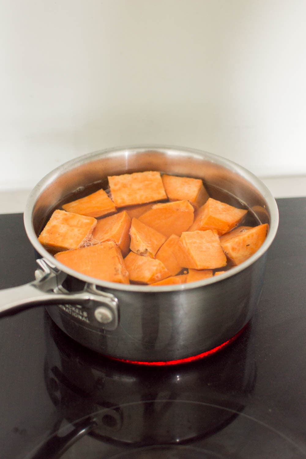 Cubed sweet potatoes in a pot of boiling water