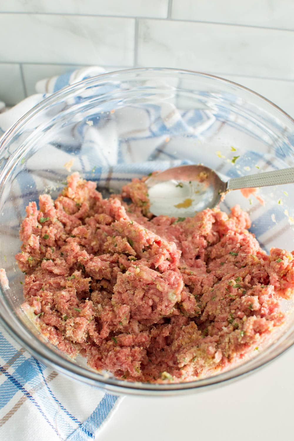 Mixing ground beef and additional ingredients to make meat balls