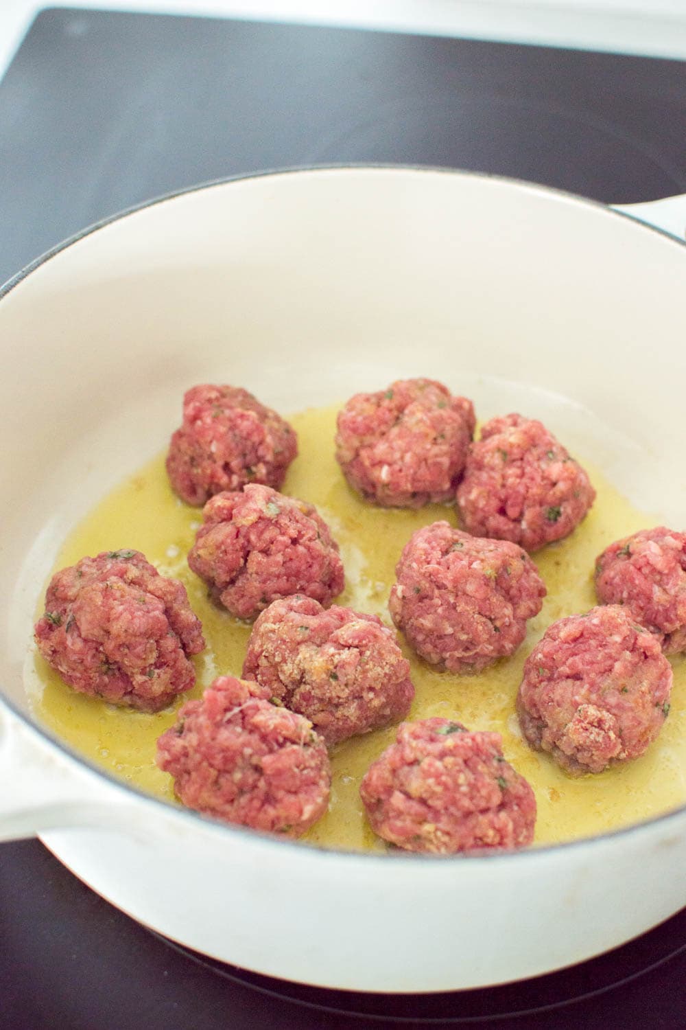 Browning meatballs in a large skillet