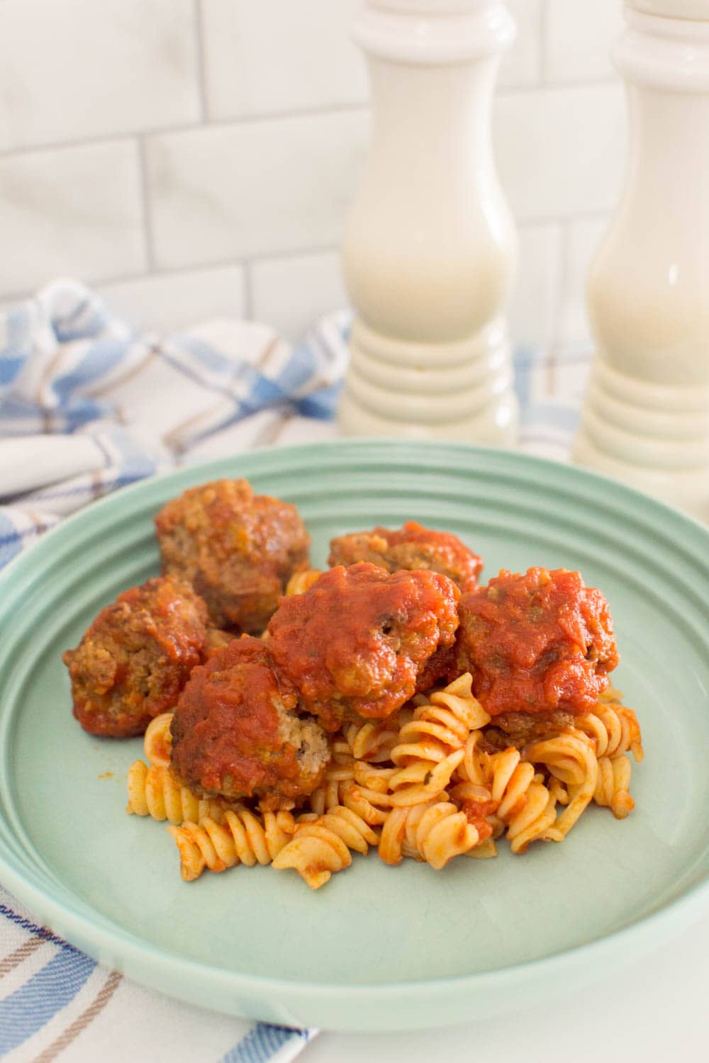 Our easy meatball recipe on top of past and covered in marinara sauce
