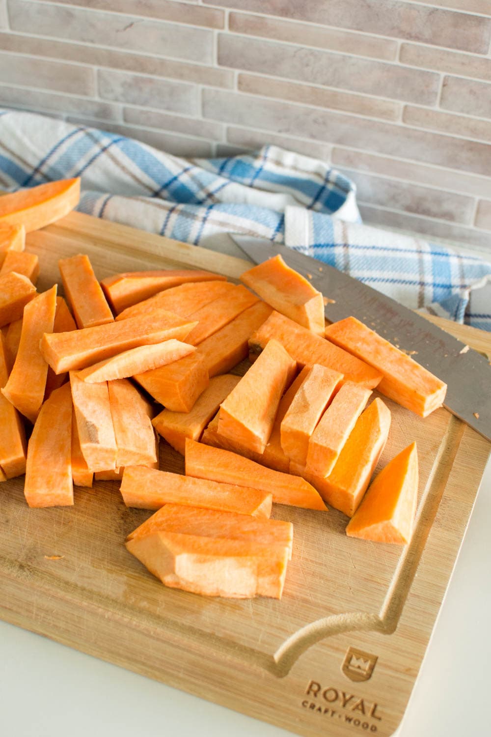 Slices of sweet potatoes on a wooden cutting board