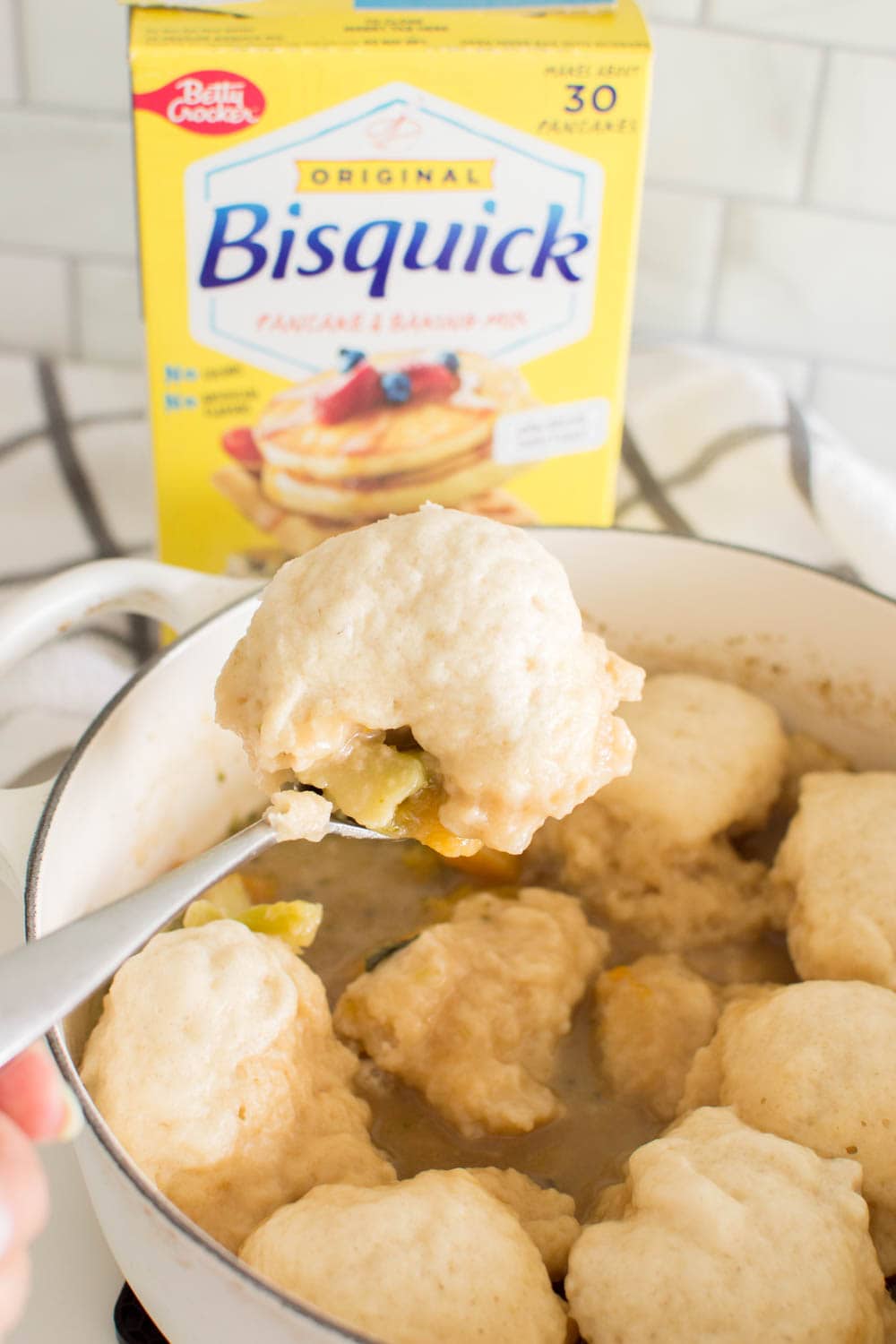 Pulling out a Bisquick Dumpling from a homemade stew