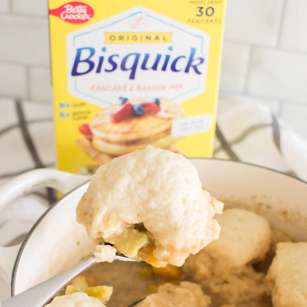 Pulling out a Bisquick Dumpling from a homemade stew