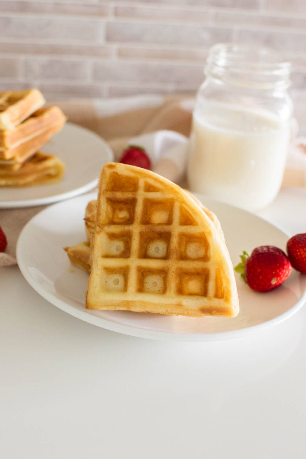 A quarter of an easy homemade waffle on a white plate
