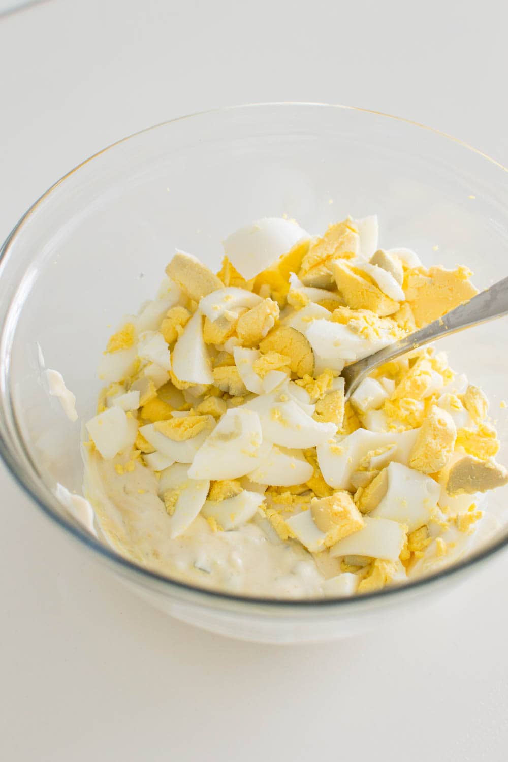 Adding chopped hard boiled eggs into homemade salad dressing