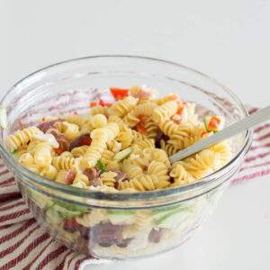 A large glass bowl filled with homemade pasta salad