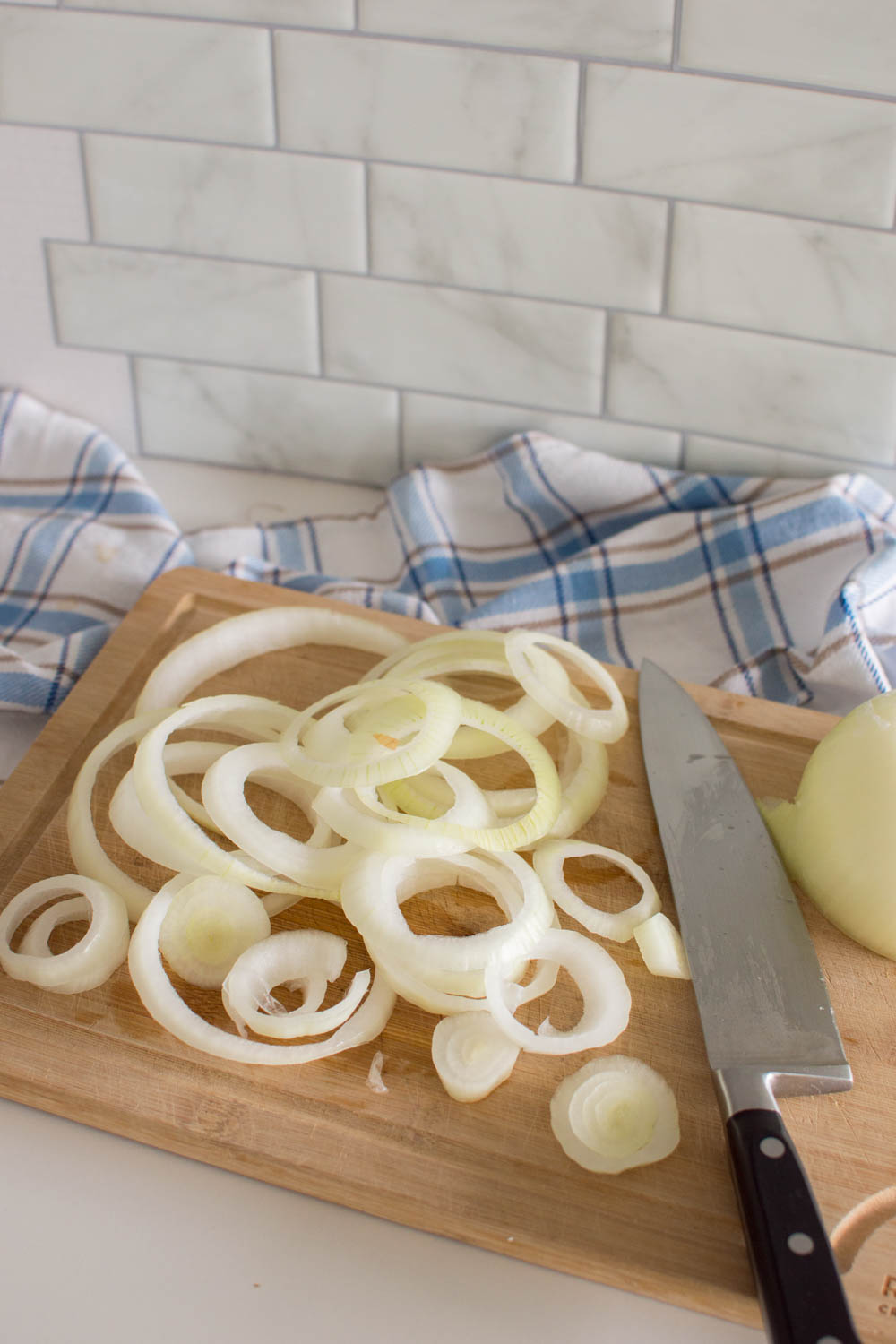 Cutting onions into rings on a wooden cutting board