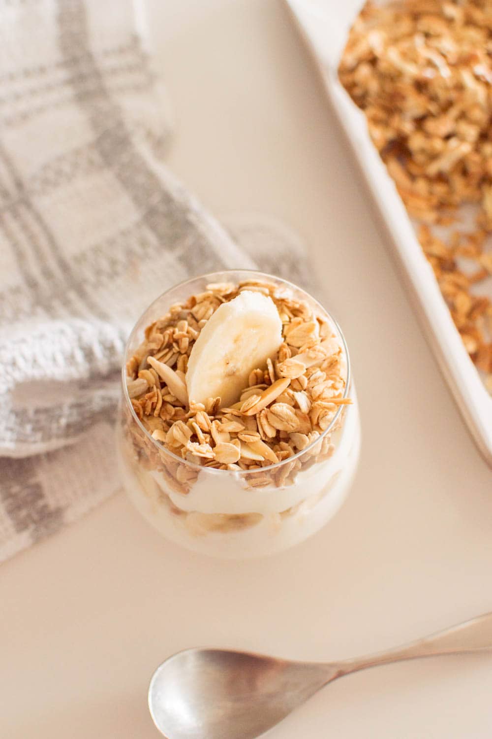 Aerial short of homemade granola served on top of yogurt and topped with a banana