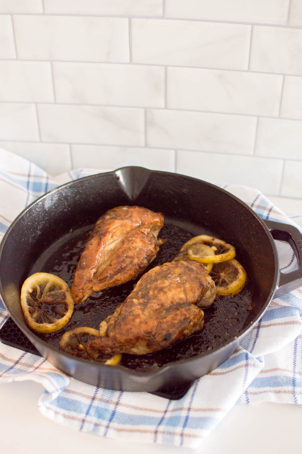 Easy lemon chicken, fresh from the stove, on a cast iron skillet