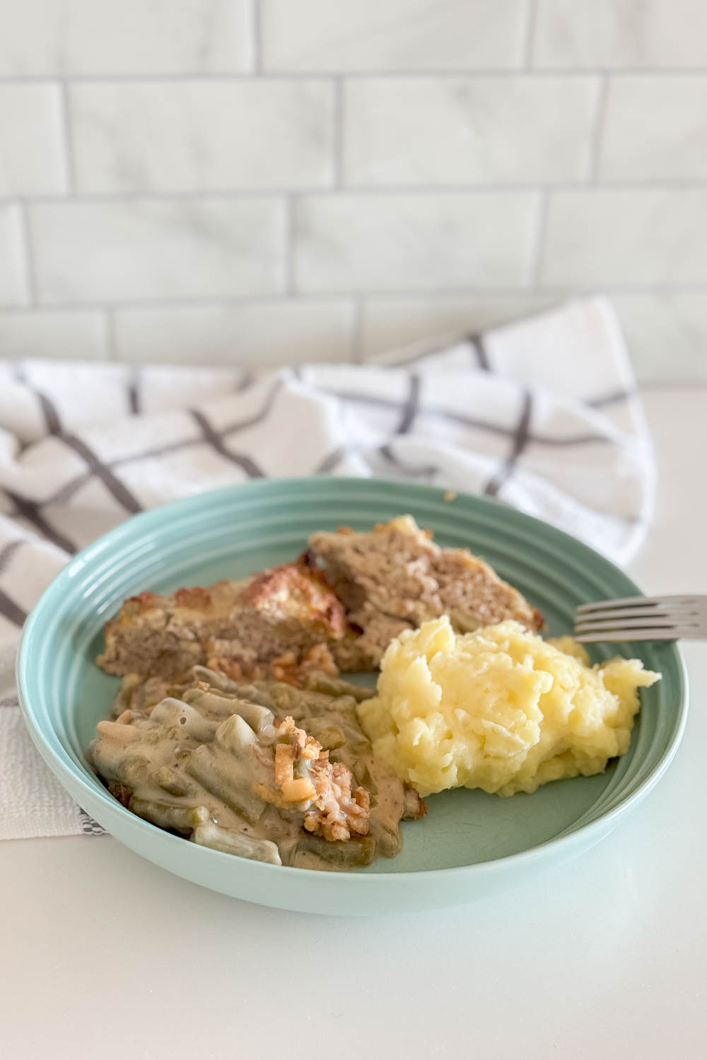 Presenting our ground turkey meatloaf on a platter with side dishes